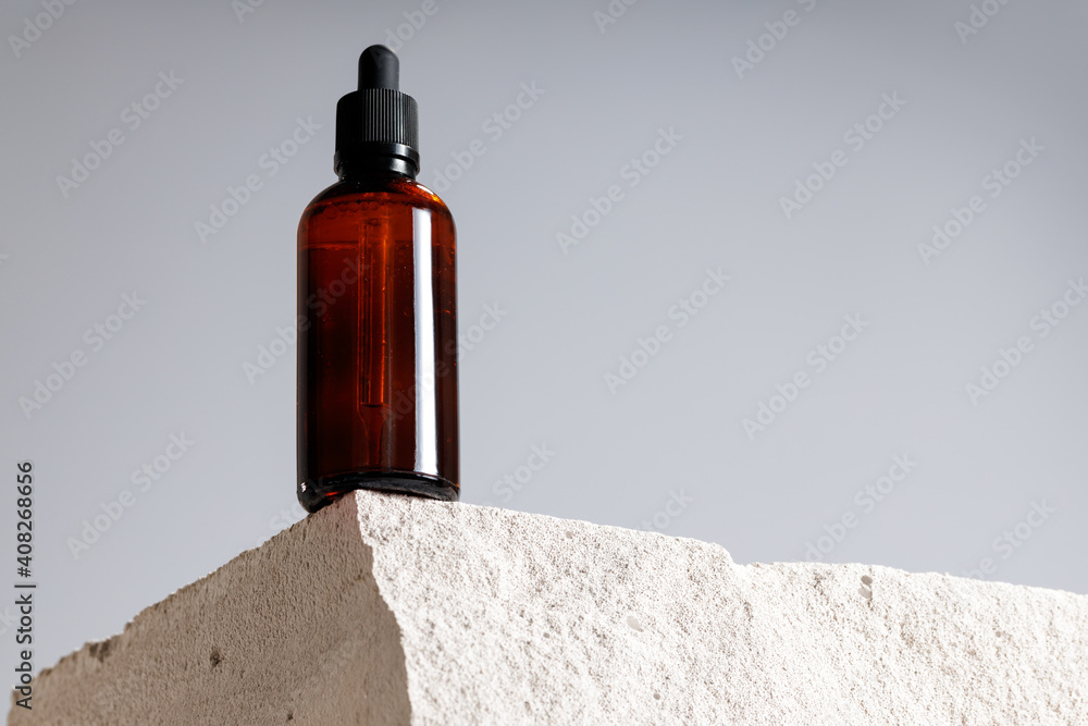 Glass bottle with cosmetic oil on cinder block Glass bottle with cosmetic oil on cinder block
