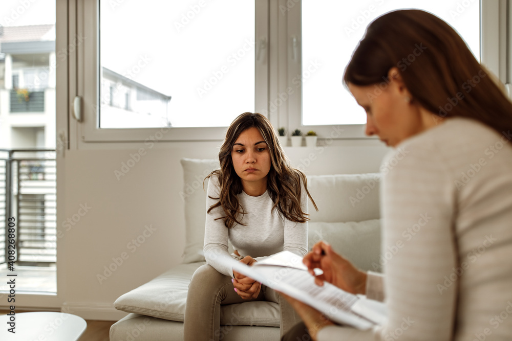 Woman visiting psychologist, window in the background. Woman visiting psychologist, window in the background.