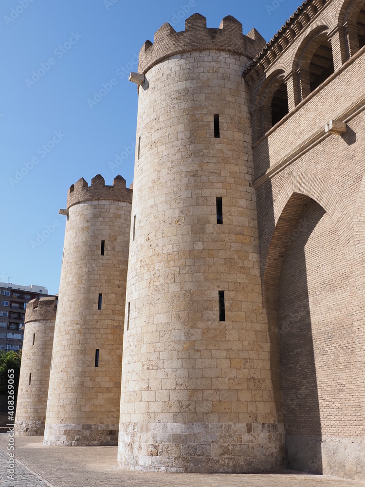 Enormous palace in european Saragossa city at Aragon district in Spain, clear blue sky in 2019 warm sunny summer day on September - vertical.