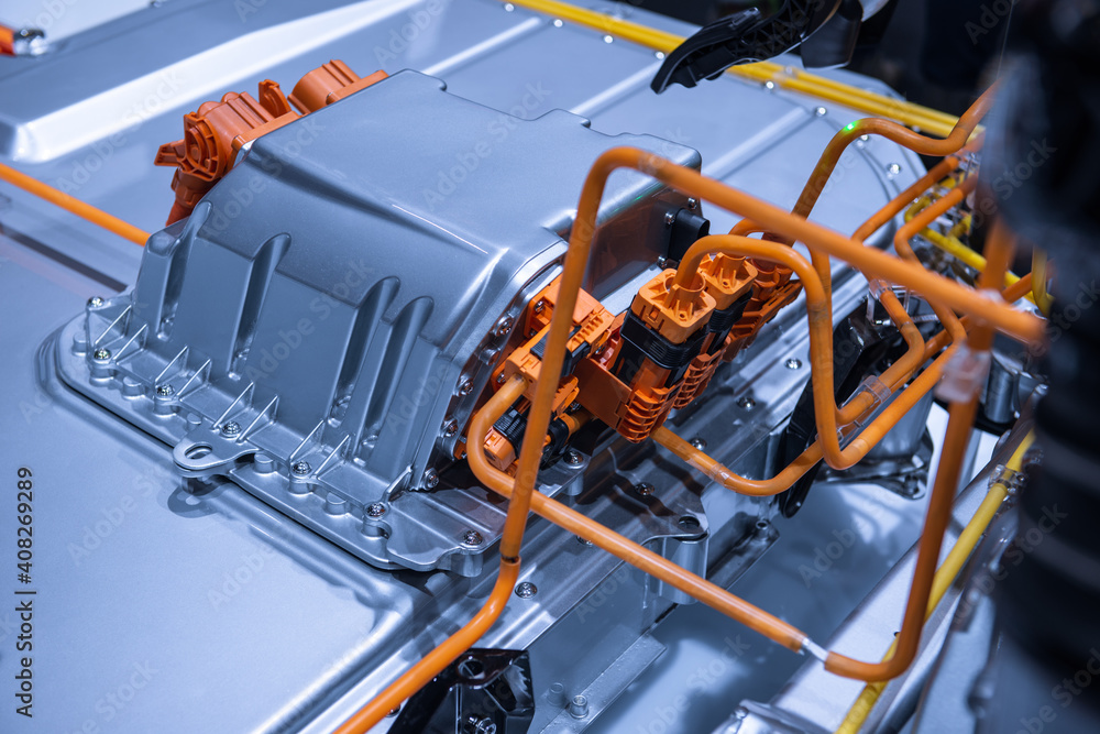Fototapeta premium Chassis of the electric car with powertrain and power connections closeup. Blue toned. EV car drivetrain at maintenance.