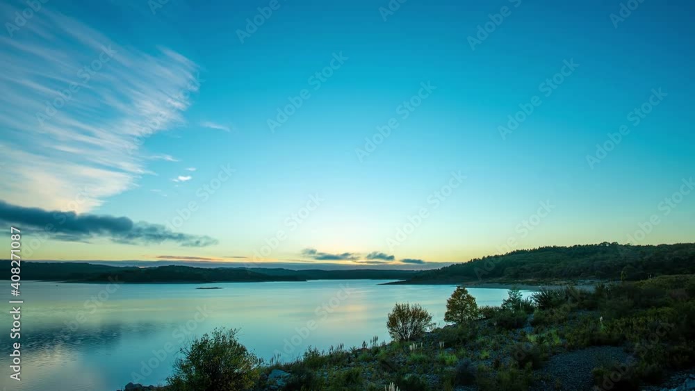Time-lapse of landscape at sunrise and cirrus clouds floating in the sky Time-lapse of landscape at sunrise and cirrus clouds floating in the sky