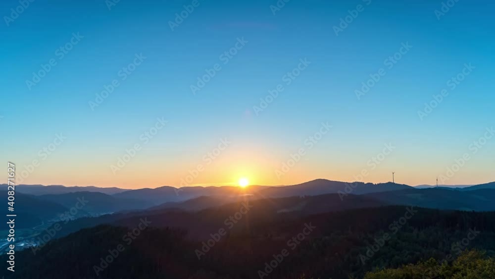 Time-lapse, German Black Forest at sunrise, mountain scene illuminated by golden sunlight Time-lapse, German Black Forest at sunrise, mountain scene illuminated by golden sunlight