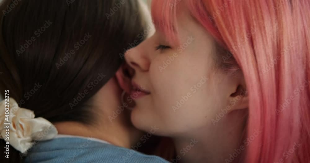 Loving female gay couple kissing and embracing at home Loving female gay couple kissing and embracing at home