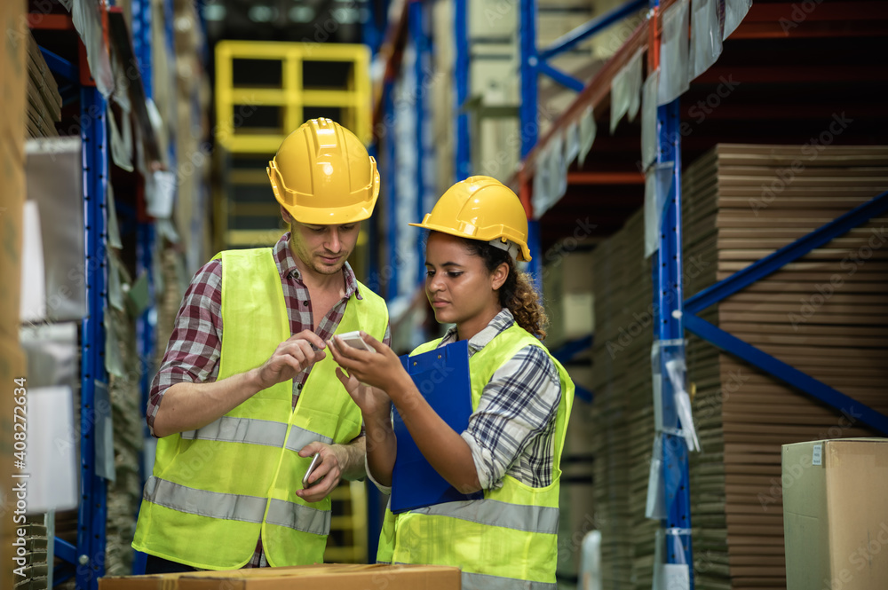 Diverse of people Caucasian and African warehouse workers working and discussing seriously about inventory balance in storage room together. warehouse and inventory concept. Diverse of people Caucasian and African warehouse workers working and discussing seriously about inventory balance in storage room together. warehouse and inventory concept.