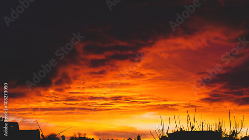Beautiful sunset over the village. Fluffy clouds.