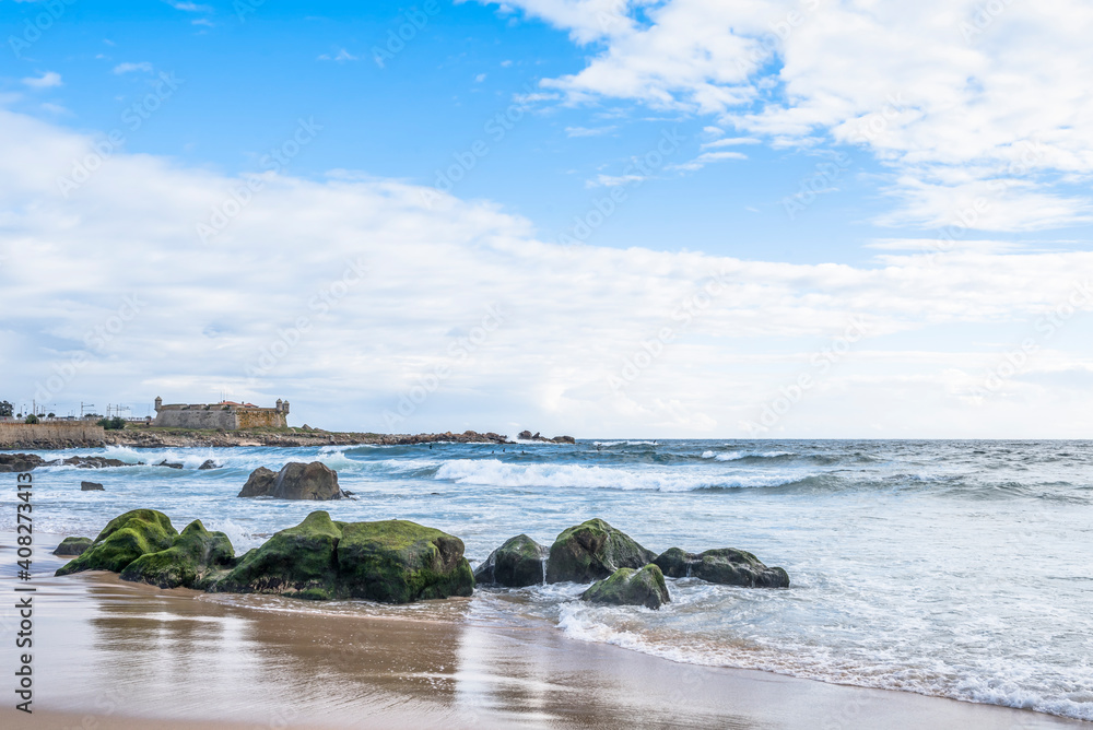 Atlantic ocean in Western Europe in Porto, Portugal. Castle of the Cheese of 15th century in the distance