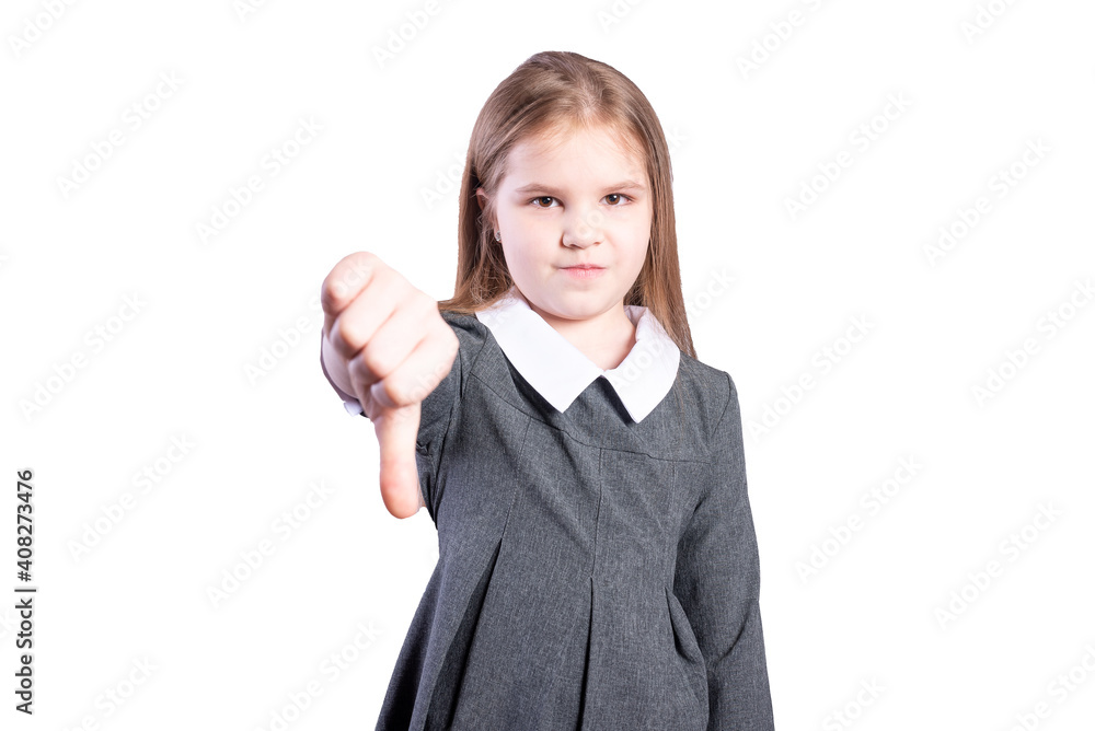 Schoolgirl shows her thumbs down. Isolated on white background. Schoolgirl shows her thumbs down. Isolated on white background.