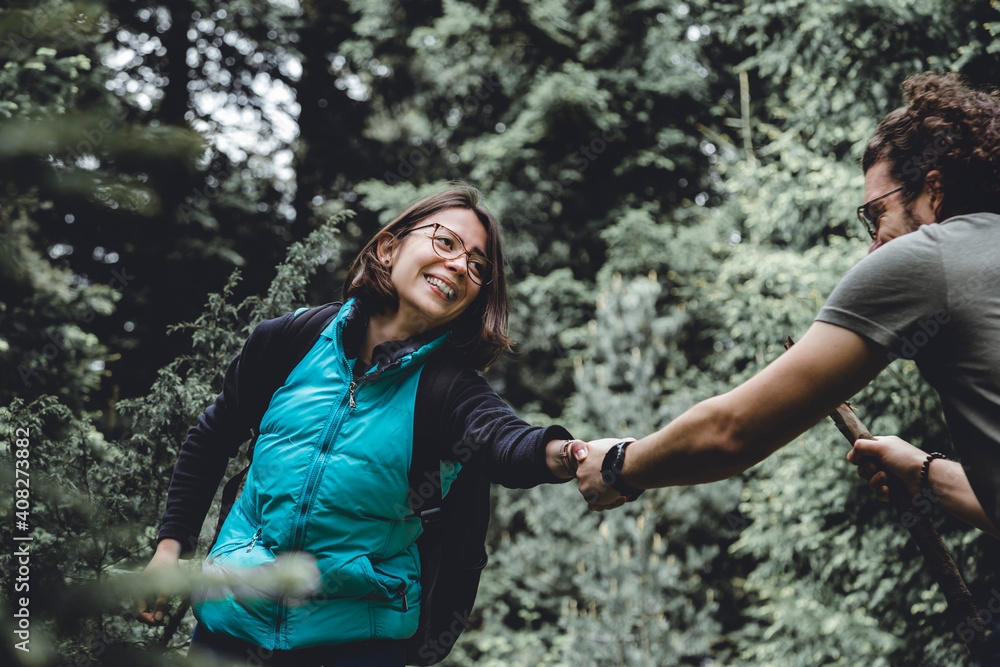 Couple hiking and having fun spending time in nature Couple hiking and having fun spending time in nature