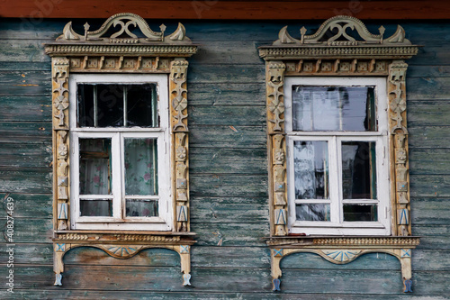 Russia  Tver region. 07.18.2020  Old wooden house with windows in beautiful carved platbands