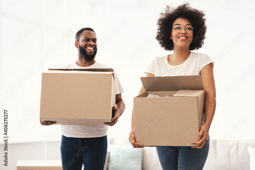 African American Spouses Carrying Moving Boxes Into New House African American Spouses Carrying Moving Boxes Into New House