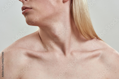 Collarbone of young naked man with head turned to side