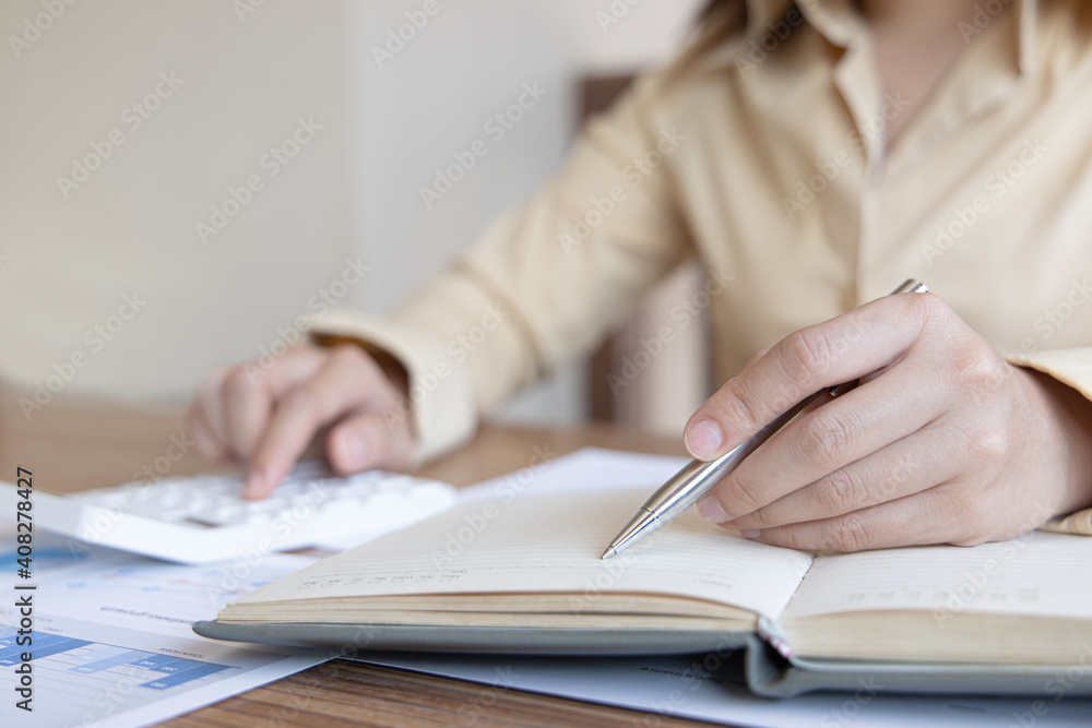 Head of accounting is recording the company's financial growth statistics using graphs as a reference for reviewing and analyzing the results, Taking notes and analyzing data graphs in office. Head of accounting is recording the company's financial growth statistics using graphs as a reference for reviewing and analyzing the results, Taking notes and analyzing data graphs in office.