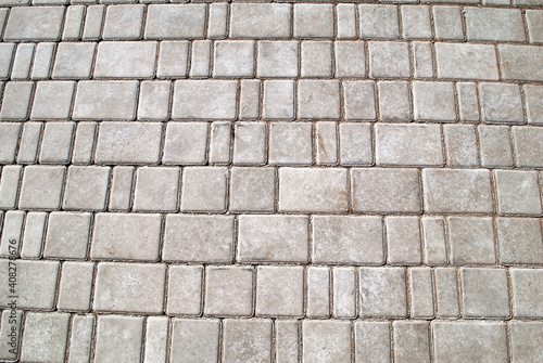 Gray paving stones. Gray sidewalk, rectangular and large and small. Tile texture.