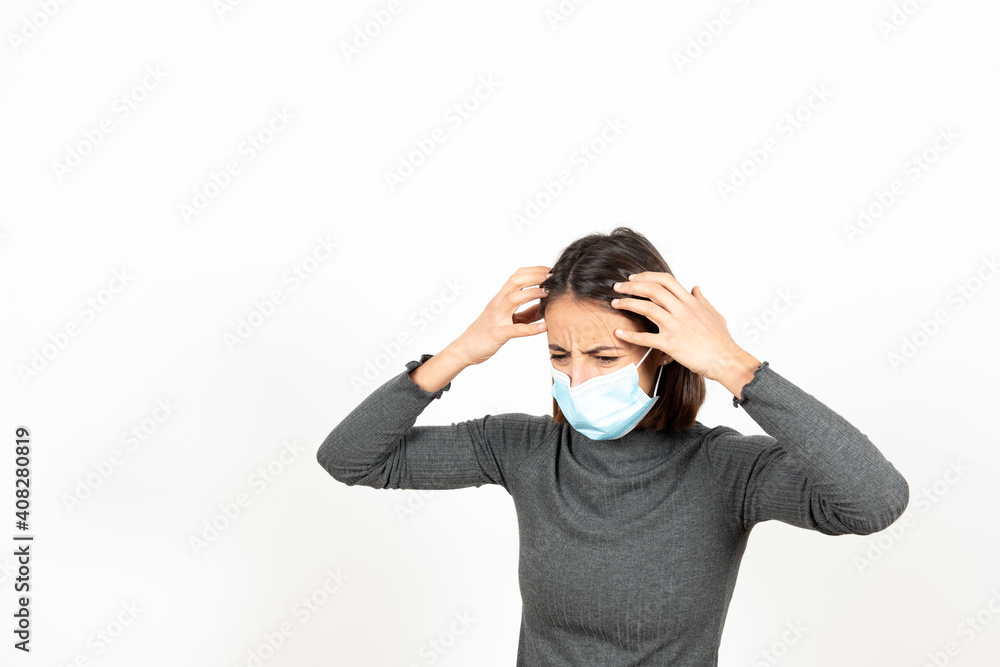 Dispaired hispanic woman wearing a surgical face mask. Mental health during Coronavirus pandemic concept. Dispaired hispanic woman wearing a surgical face mask. Mental health during Coronavirus pandemic concept.