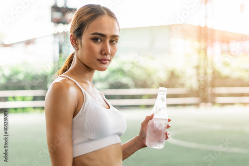 woman drink water after hard workout prevent dehydration heat stroke. photo