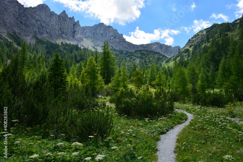 Hiking trail leading through a mountain valley
