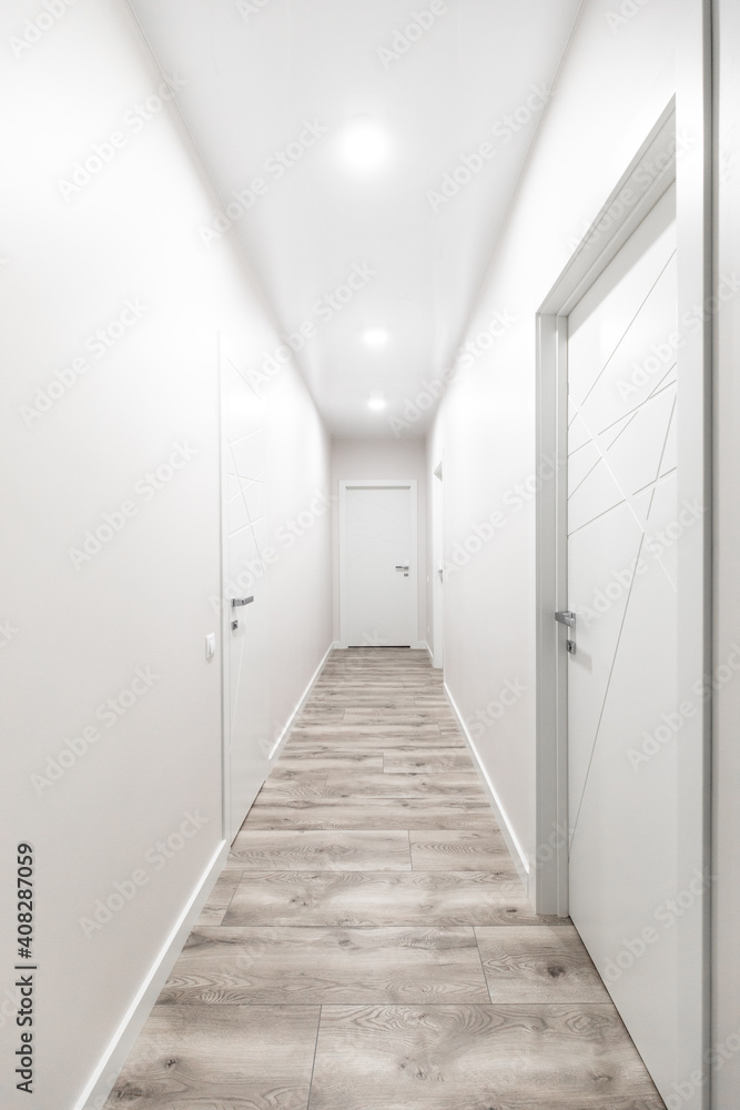 White corridor with white doors in the flat