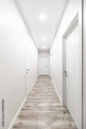Fototapeta Naklejka Na Ścianę i Meble -  White corridor with white doors in the flat