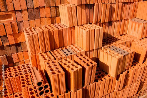Stacks of red and brown clay bricks and blocks for general construction and reform