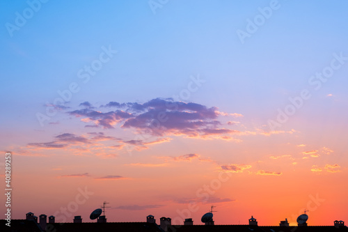 multicolored sunset sky above rooftops