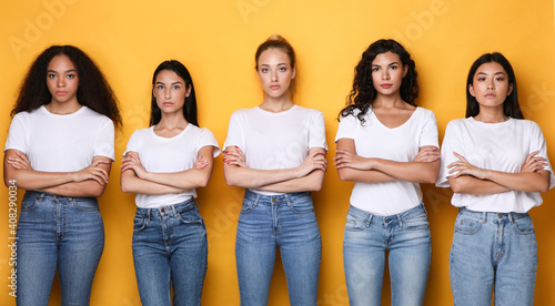 Billede på lærred Offended Multiracial Females Group Crossing Hands Posing On Yellow Background