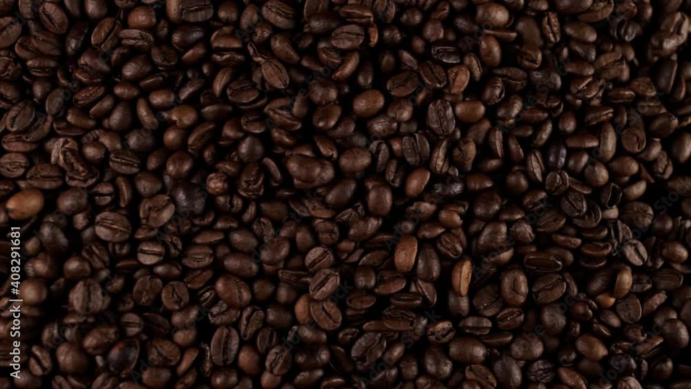 a fresh roasted coffee beans falling on the table a fresh roasted coffee beans falling on the table