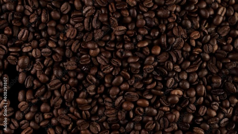 a fresh roasted coffee beans falling on the table a fresh roasted coffee beans falling on the table