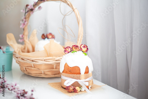 Traditional russian easter cake on table. The decorarion of kulich are the flower are eating on spring holiday