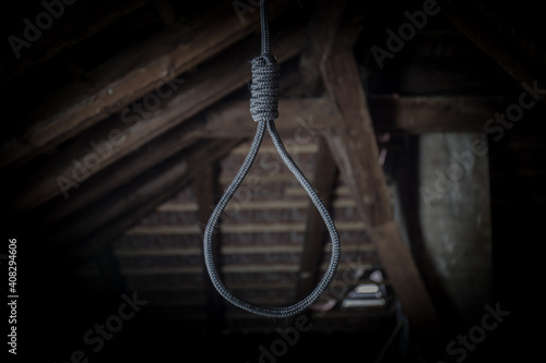A noose hanging around his neck, a suicide committed, horrific scenes in a dark attic photo