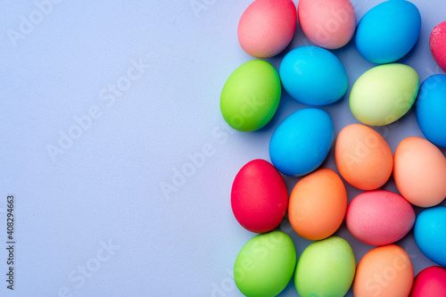 Colorful Easter eggs on blue background top view