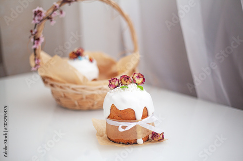 Traditional russian easter cake on table. The decorarion of kulich are the flower are eating on spring holiday