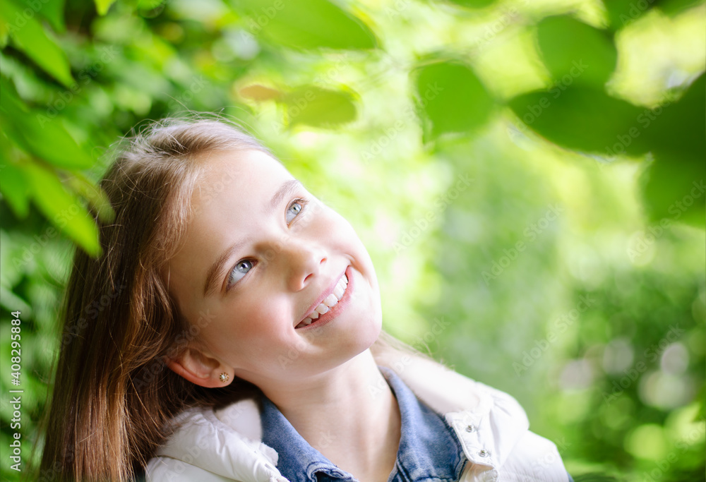 Portrait of adorable smiling little girl child preteen in the park outdoors Portrait of adorable smiling little girl child preteen in the park outdoors