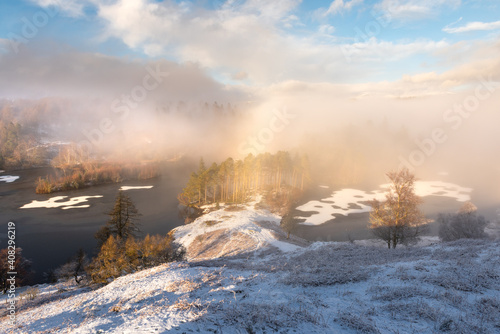 Misty frozen lake on a crisp Winter afternoon with fogbow. View out to Tarn Hows in the Lake District, UK. © _Danoz