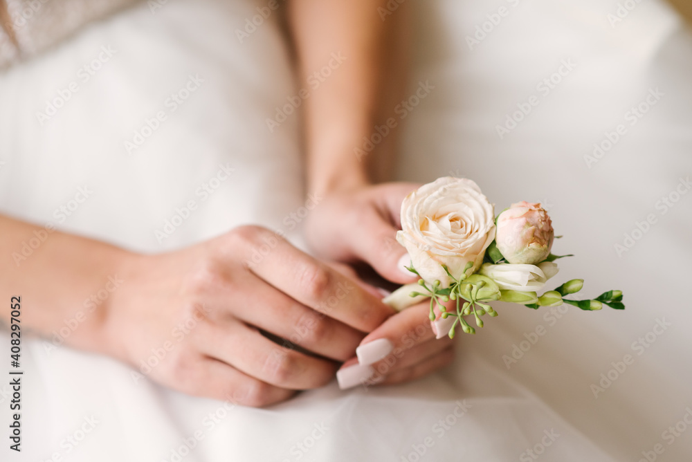 Close up bride holding buttonhole in hands Close up bride holding buttonhole in hands