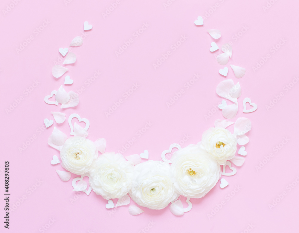 Circle frame made of cream flowers and hearts on a light pink background