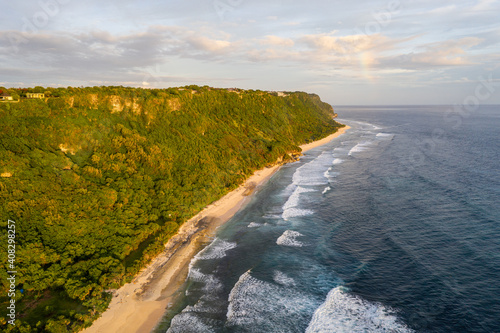 Stunning aerial view of the famous Nyang Nyang beach at the feet of the Uluwatu cliff in Bali, Indonesia photo