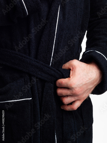 man in a bright, bath robe advertises clothing details on an isolated white background.