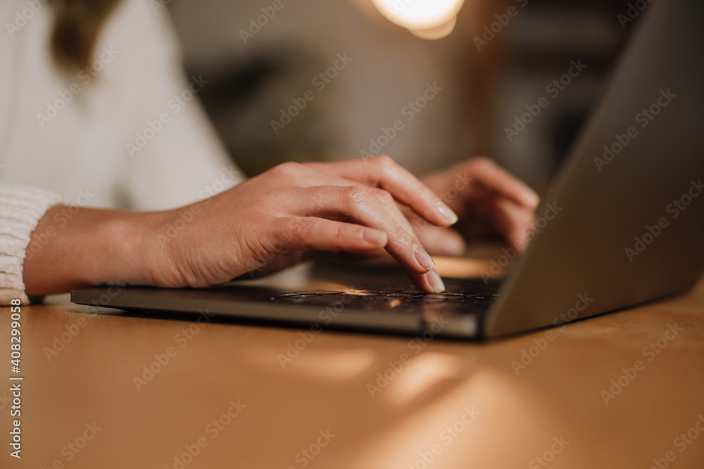 Female hands typing on a laptop Female hands typing on a laptop
