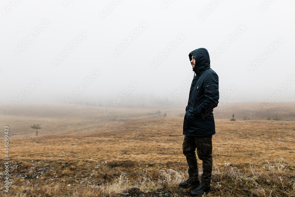 Young man exploring nature on a wet winter morning in the mountains Young man exploring nature on a wet winter morning in the mountains
