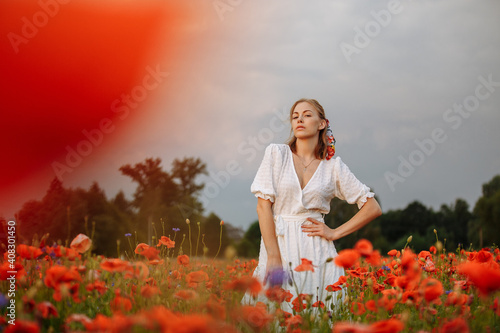 portrait of a girl in a field of poppies