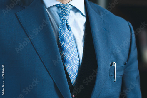 man in blue suit with pen in pocket