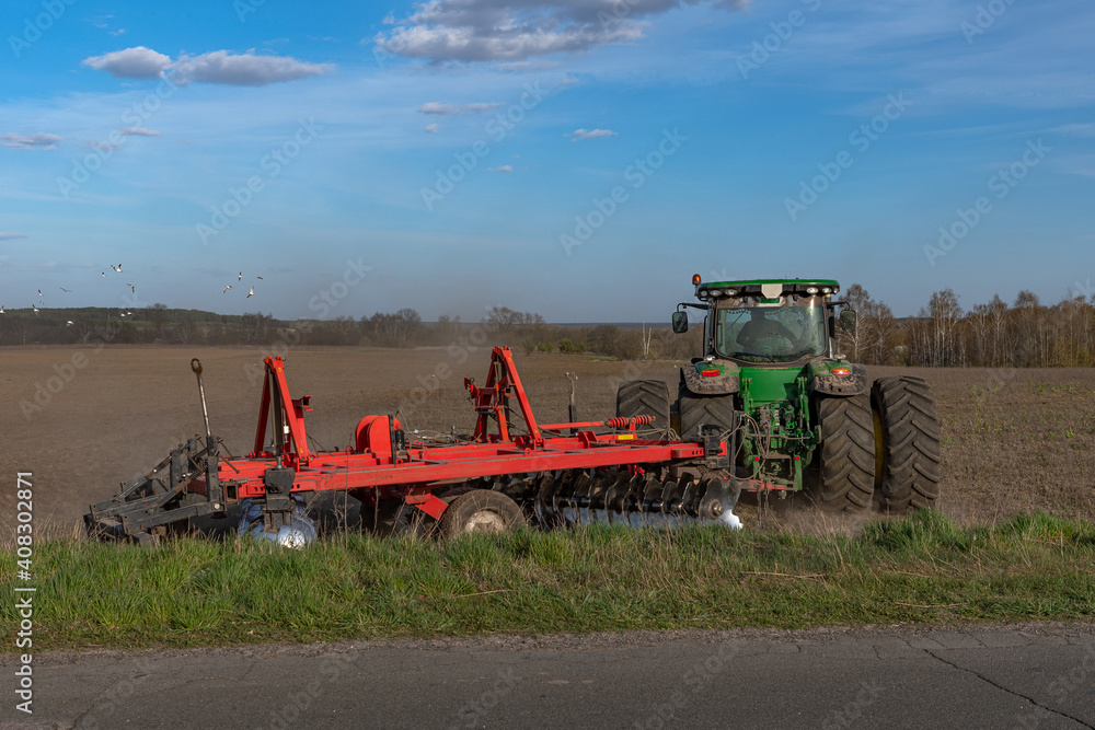 Fototapeta premium plowing the land with machinery
