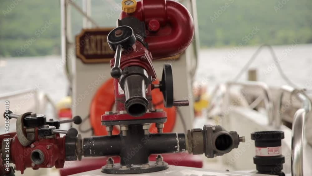 Fire Hydrant and a Fire Hose Nozzle mounted on the Bow of a Fireboat Parked at a Marina Fire Hydrant and a Fire Hose Nozzle mounted on the Bow of a Fireboat Parked at a Marina
