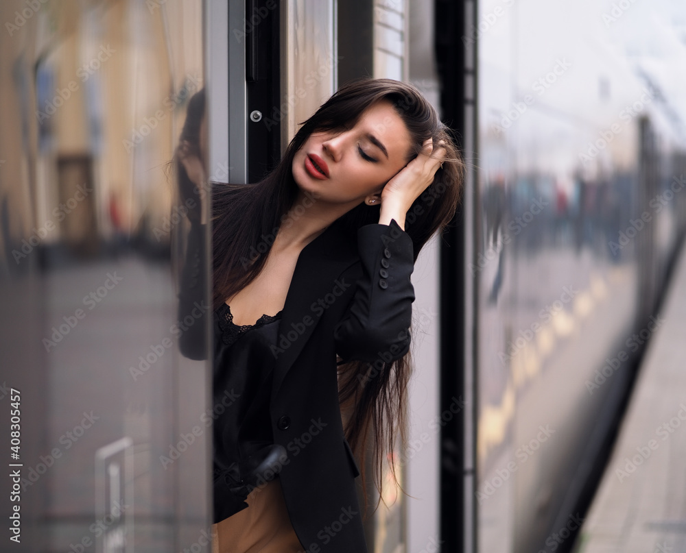 Woman model near train in suit Woman model near train in suit