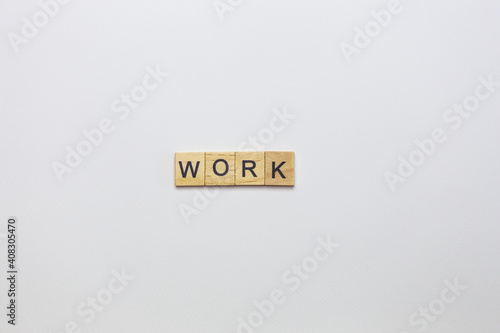 Wooden cubes, inscription on a white background - a robot. View from above.