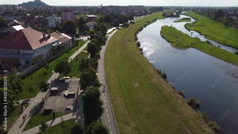 View of the Latorica river in the city of Mukachevo. Houses from above. Summer and trees. Drone Video. Ukraine. Europe View of the Latorica river in the city of Mukachevo. Houses from above. Summer and trees. Drone Video. Ukraine. Europe