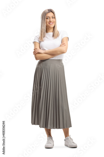 Obraz na plátně Full length portrait of a young blond woman in a pleated skirt