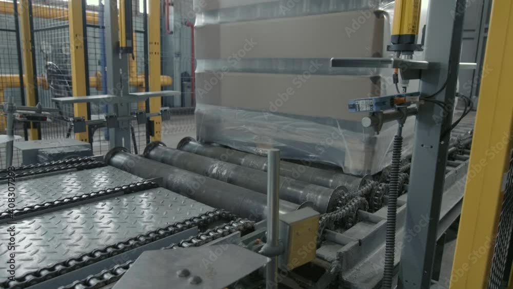 The work of the packaging machine for the production of glass-blowing products at the plant The work of the packaging machine for the production of glass-blowing products at the plant