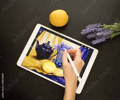 A girl's hand draws a still life picture with a pencil on an electronic tablet. The concept of inspiration, creativity, self-development, hobby, modern art