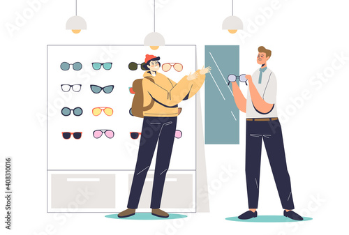 Young hipster man in optics store trying fashionable eyeglasses with male shop assistant